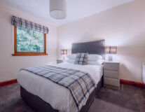 a bedroom with a bed and desk in a hotel room a bedroom with a bed and desk in a hotel room